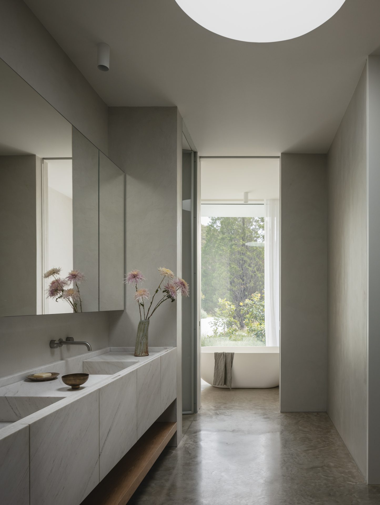 Ensuite vanity with views through to the freestanding bath at Melody House